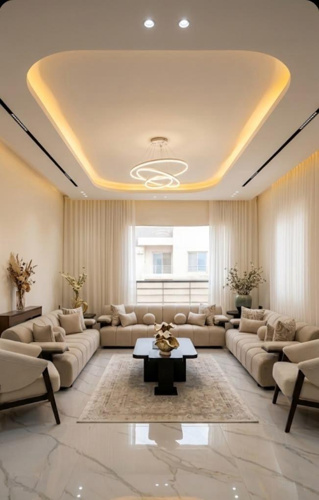 Capsule false ceiling living hall with warm ambient cove lighting and ring chandelier in Bhopal